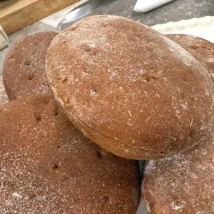 En hög med nybakade rågkakor, perfekta för ett enkelt rågkaka recept. Strödda med mjöl.