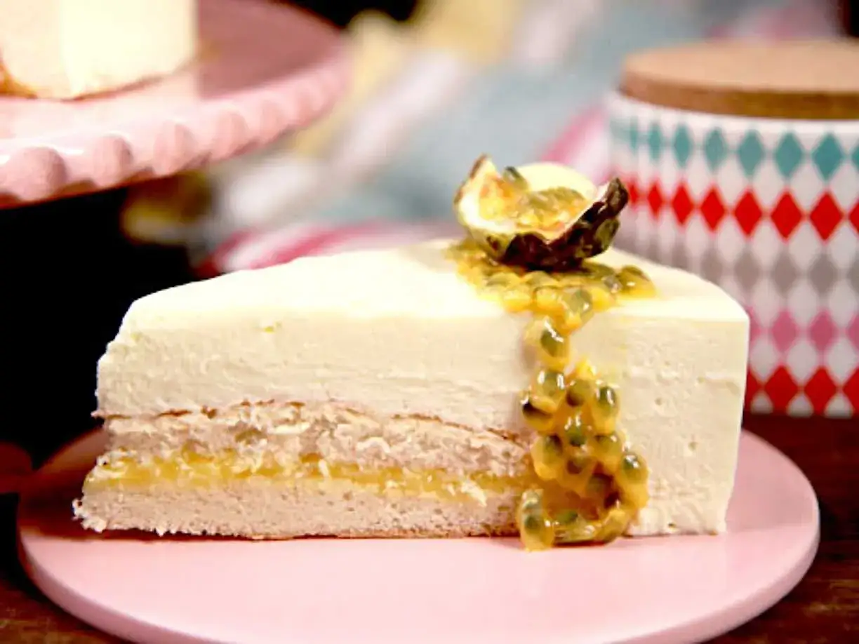 En bit kr&auml;mig mousset&aring;rta passionsfrukt med saftig passionsfruktss&aring;s och en halv passionsfrukt som dekoration.